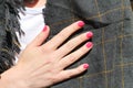 Beautiful female hand with manicure. Saturated bright pink nail polish and and groomed fingers.