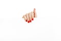 Beautiful female hand with red nails holding a blank sign Royalty Free Stock Photo