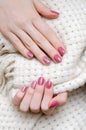 Beautiful female hand with warm pink nail design