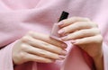 Beautiful female hand with warm pink nail design