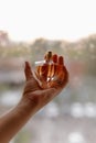 Beautiful female hands, a girl holding a bottle of perfume in her hands Royalty Free Stock Photo