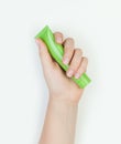 Beautiful female hands with green creame tube