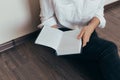 Beautiful female hands hold an open book or magazine in the room Royalty Free Stock Photo