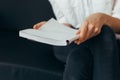 Beautiful female hands hold an open book or magazine in the room Royalty Free Stock Photo