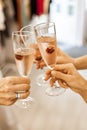 Beautiful female hands are holding glasses of champagne or rose wine. Close-up. Women clink glasses. New Years celebration, event Royalty Free Stock Photo