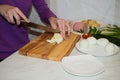 Beautiful female hands with a knife sliced boiled egg Royalty Free Stock Photo