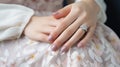 Hands of the bride with wedding nail design