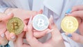 Beautiful female hands with manicure holding 3 souvenir coins of Bitcoin cryptocurrency Royalty Free Stock Photo