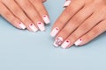 Female hands with romantic manicure nails, hearts design