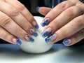 Beautiful female hands with a transparent manicure and fashionable design.