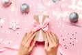 Beautiful female hands with trendy manicure holding gift box on festive christmas background Royalty Free Stock Photo