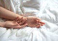 Female hands on white bedding
