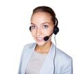 Beautiful female with a headset isolated on white. Cute young business woman speaking over the headset against white. Royalty Free Stock Photo