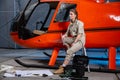 Beautiful female helicopter mechanic at work. feminism