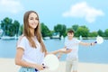 Young couple in love playing with matkot rackets