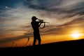 Female Hunter silhouette in Sunset. Royalty Free Stock Photo