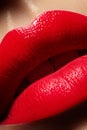 Beautiful female Lips. Sweet Kiss with red lipstick. Lip Make-up on macro shoot. Hot fashion lip makeup