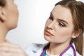 Beautiful female medicine doctor with serious face examine patient