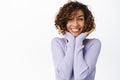 Beautiful female model with curly natural hair, smiling happy and laughing, looking with excitement, standing in purple Royalty Free Stock Photo