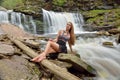 Beautiful female model posing in front of waterfall Royalty Free Stock Photo