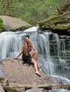 Beautiful female model posing in front of waterfall Royalty Free Stock Photo