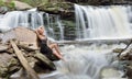 Beautiful female model posing in front of waterfall Royalty Free Stock Photo