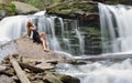 Beautiful female model posing in front of waterfall Royalty Free Stock Photo