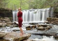 Beautiful female model posing in front of waterfall Royalty Free Stock Photo