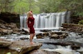 Beautiful female model posing in front of waterfall Royalty Free Stock Photo