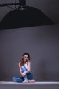 Beautiful female model posing at studio in the light softbox Royalty Free Stock Photo