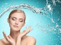 Beautiful female model with splashes of water in her hands. Royalty Free Stock Photo