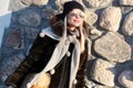 Beautiful female model in sunglasses and a winter hat on a cold sunny day. A woman walks around the city of Minsk Royalty Free Stock Photo