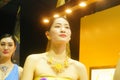 Beautiful female models show gold jewelry at the Shenzhen International Jewelry Show