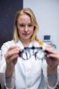 Beautiful female optometrist holding messbrille