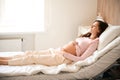 Female patient lies on bed in hospital ward before childbirth Royalty Free Stock Photo