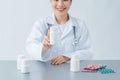 Beautiful female physician medicine doctor or pharmacist sitting at worktable