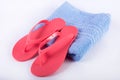 Pink sandal flip flop on blue towel and white background