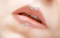 Beautiful female pink lips with glittering gems art decoration. Pink lipsgloss with bright jewel stones decor