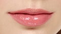 Sensual female pink plump lips close up.