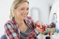 beautiful female plumber working on central heating boiler Royalty Free Stock Photo