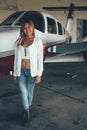 Beautiful female portrait in the airplane hangar, with modern ai Royalty Free Stock Photo