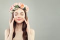 Beautiful female portrait. Healthy spa model wodel with clear skin, brown hair and spring flowers