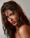 Beautiful female portrait with long wet hair, studio shot. Genuine natural redhead looking directly to the camera after a shower. Royalty Free Stock Photo