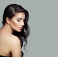 Beautiful female profile. Cute brunette woman with natural makeup and long black hair on gray background Royalty Free Stock Photo