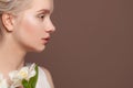 Beautiful female profile white flowers on brown background