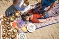 Beautiful female receiving energy sound massage with singing bowls and body massage on a river bank Royalty Free Stock Photo