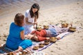 Beautiful female receiving energy sound massage with singing bowls and body massage on a river bank Royalty Free Stock Photo