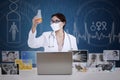 Beautiful female scientist analyse formula on blue digital