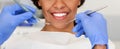 Beautiful female smile and dentist hands with tools Royalty Free Stock Photo