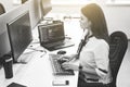 Beautiful female software developer working on computer in IT office, sitting at desk and coding, working on a project Royalty Free Stock Photo